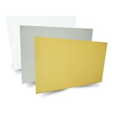 three different colors of paper stacked on top of each other, one yellow and the other white