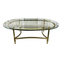 an oval glass table with metal legs