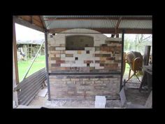 an outdoor kitchen with a brick oven and grill