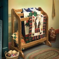 a wooden crib filled with quilts and blankets