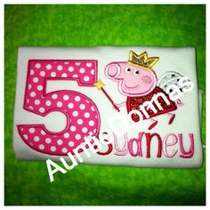 a pink and white birthday cake with pep the pig on it's number five