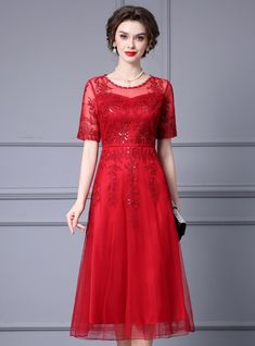 Glamour meets timeless elegance in this stunning red dress, designed to make you feel like a true star. The dress features a beautifully tailored fit that enhances your natural curves, with a fitted bodice and a flowing skirt that creates a flattering silhouette. The semi-sheer overlay is embellished with intricate floral embroidery, adding depth and sophistication to the design. The short sleeves and round neckline offer a modest yet elegant look, perfect for various formal events. The dress cinches at the waist to accentuate your figure, providing a timeless and elegant appeal. Crafted from premium quality fabric, this dress guarantees both comfort and durability, ensuring it remains a cherished piece in your wardrobe. The rich red color is striking and versatile, suitable for making a s Elegant Red Mother Of The Bride Dress For Banquet, Red Knee-length Evening Dress For Prom Season, Red Knee-length Evening Dress For Prom, Elegant Red Fitted Mother Of The Bride Dress, Elegant Red Mother Of The Bride Evening Dress, Elegant Red Dress For Banquet, Red Fitted Midi Evening Dress, Red Midi Dress For Banquet, Elegant Red Floor-length Mother Of The Bride Dress