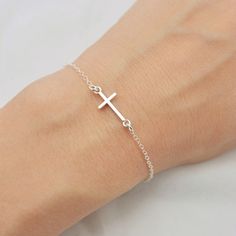 ALL SOLID 925 STERLING SILVER - A QUALITY BRACELET I make this lovely bracelet using a solid sterling silver cross that measures just under 3/4 inch long. A sturdy sterling silver chain and lobster clasp make this a durable bracelet. Makes a wonderful layering bracelet when paired with my other pieces. Comes in a gift box perfect for gift giving. SIZING - IMPORTANT: To determine bracelet size, measure snugly around your wrist and add 1/2 inch. If you don't know your size, you can use the sizing Silver Cross Bracelet, Tiny Cross, First Communion Gifts, Communion Gifts, Confirmation Gifts, Cross Bracelet, Layered Bracelets, Sterling Silver Cross, Silver Cross