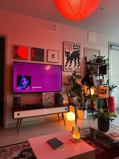 a living room filled with furniture and a large flat screen tv mounted on the wall