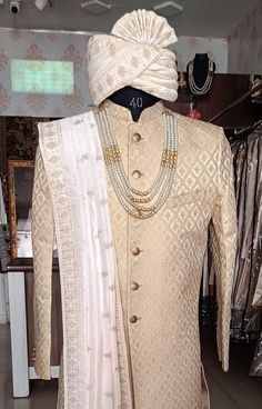 This is a Classic  Suit by Golden Attire crafted from high quality fabric and imported materials. Our products are handcrafted by experienced tailors who make sure the that the stitching is precise, lining is proper and the overall product is sturdy enough to not go out of shape for more than a few years. Also all our products have extra margins in their length, sleeves, sides so it's easily alterable if your size changes after some time. To see more available colours and designs in this collect Traditional Gold Sherwani For Ceremonies, Gold Sherwani With Dupatta For Traditional Ceremonies, Traditional Sets With Chikankari Embroidery For Groom, Traditional Nehru Jacket With Traditional Drape For Wedding, Traditional Groom Sets With Chikankari Embroidery, Traditional Wear With Naqshi For Wedding, Gold Sherwani For Traditional Ceremonies, Ceremonial Off White Sherwani With Pallu, Gold Sherwani For Traditional Ceremonies In Transitional Season