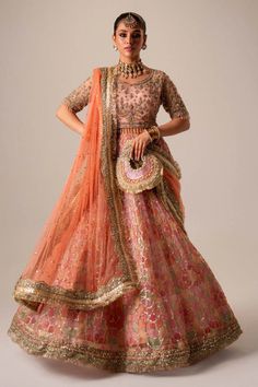 Premium Pakistani Bridal Dress in Organza Choli Lehenga Style is adorned with hand-crafted details of dabka, gota, kora, naqshi, and threads. The choli has an alluring pink shade and the Bridal Lehenga is multi-colored, creating a lavish Lehenga Dress for the bride to wear on the big day. Floor-length Sets With Intricate Embroidery For Navratri, Embroidered Organza Gown For Navratri, Navratri Organza Embroidered Gown, Navratri Embroidered Organza Gown, Navratri Sets With Intricate Embroidery In Floor-length, Anarkali Set With Dabka Work For Reception, Dabka Work Anarkali Set For Reception, Festival Anarkali Set With Dabka Work For Reception, Traditional Wear With Dori Work For Eid Reception