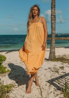 Yellow Bohemian maxi dress with button up detailing Chic Rayon Maxi Dress For Beach Cover-up, Breezy Rayon Midi Dresses, Maxi Sundress For Beach Daywear, Flowy Summer Midi Dress For Daywear, Solid Color Flowy Dress For Beach Season, Maxi Length Sundress For Beach Daywear, Flowy Solid Dress For Beach Season, Flowy Solid Color Dress For Beach Season, Summer Dresses With Smocked Back For Beach Cover-up