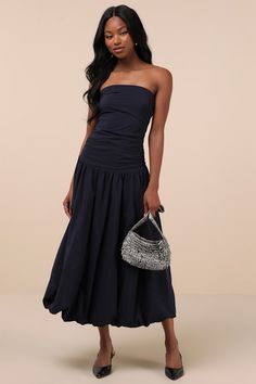 When you're known for wearing looks like the extro&vert Caggie Navy Strapless Drop Waist Midi Dress, it's no wonder why your inbox is full of invites! Sleek, stretch-woven fabric shapes this lovely dress that features a strapless bodice with hidden no-slip strips and a straight neckline. The fitted silhouette boasts flattering ruching throughout as it falls to a trendy drop waist, all atop a chic A-line midi skirt that finishes at a voluminous bubble hem. Hidden back zipper/clasp. Fit: This garment fits true to size. Length: Mid-calf length. Size medium measures 49" from top to bottom. Bust: Great for any cup size. Waist: Fitted - very fitted at natural waist. Hip: Not Fitted - fuller skirt allows room for hips. Undergarments: May be worn with a strapless bra, adhesive bra, petals, or no b Drop Waisted Dresses, Dress For Apple Shape Women, Black Graduation Dress, Midi Wedding Guest Dress, Dresses For Apple Shape, Maid Of Honor Dress, Drop Waist Skirt, Plum Dress, Midi Skirt Outfit