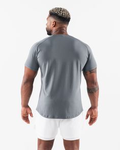 HIGHLIGHTS Fitted short sleeve Sweat-wicking, breathable fabric Rubberized aplique on chest Soft stretch fabric Straight hemline style FIT SUGGESTION. This item runs true to Alphalete’s standard. fit.. If you are between sizes, we recommend sizing up. Model is 6’0”/183cm, wearing a size XL with a 47”/120cm chest.. MATERIALS AND WASHING DIRECTIONS 96% Cotton and 4% Spandex. We recommend washing inside-out on a cold setting. Hang to dry Our Core Tee Shirt returns with an updated look and feel. Our Fitted Gray T-shirt For Sports, Short Sleeve T-shirt For Workout, Fitted Jersey T-shirt For Sports, Technical Crew Neck T-shirt For Training, Fitted Short Sleeve Sports T-shirt, Breathable Relaxed Fit T-shirt For Athleisure, Fitted Gray T-shirt For Running, Technical Athletic Fit Short Sleeve T-shirt, Gray Moisture-wicking Short Sleeve T-shirt