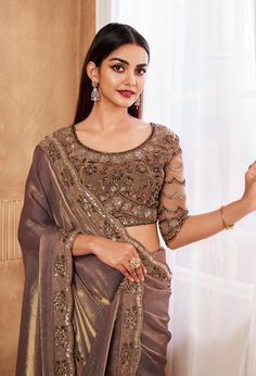 COLOR : Saddle Brown FABRIC : Saree - Fancy Silk, Blouse - Fancy Silk & Net WORK : Resham Embroidery, Stones, Sequins, Lace BorderOCCASION : Wedding, Engagement, Party Wear, Festival, Sangeet NOTE : The outfit includes blouse and saree only. Petticoat is not included. READY-TO-WEAR : No STITCHING : Available as semi-stitched fabric, can be stitched using standard size option (+$30). Note: There might be a slight color variation due to lighting and flash used during photoshoot. The bright shade seen is the best closer view of fabric's color. Fitted Organza Blouse For Eid, Organza Blouse With Intricate Embroidery And Traditional Drape, Eid Organza Blouse With Intricate Embroidery, Embroidered Organza Blouse For Wedding, Eid Organza Fitted Blouse, Semi-stitched Georgette Blouse With Zari Work, Embroidered Georgette Blouse For Diwali, Georgette Blouse With Zari Work For Reception, Festive Georgette Blouse With Pallu