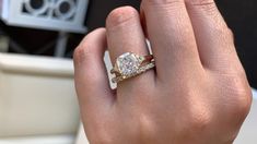 a woman's hand with a diamond ring on it