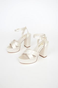 Lulus Exclusive! Kick your OOTN up a notch by slipping on the Lulus Selah Ivory Satin Ankle Strap Heels! Thick satin straps cross over a peep-toe upper, while an ankle strap wraps around ankle and secures with a gold buckle. 1"" toe platform. 4" wrapped block heel. Cushioned insole. Rubber sole has nonskid markings. Man made materials. Imported. Lulus | Selah Ivory Satin Ankle Strap Heels | Size 9. White Heels Aesthetic, Hoco Shoes, Ivy Shoes, Ivory Heels, Dr Shoes, Cute Shoes Heels, Bridal Heels, Heels Platform, Bridesmaid Shoes