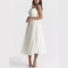 Step into elegance with our Spaghetti Strap A-Line fit and flare Midi Dress. This dress promises a graceful silhouette with its fitted bodice and flowing skirt. The spaghetti straps offer a delicate touch, perfect for both casual outings and special occasions. Made from lightweight, breathable fabric, it's designed for comfort without sacrificing style. Pair it with sandals for a relaxed look or heels to make a statement. Versatile and chic, this midi dress is a wardrobe must-have. Color: White, Summer A-line Suspender Dress With Fitted Bodice, Elegant Midi Dress With Fitted Bodice And Straps, Fitted Bodice Spaghetti Strap Sundress For Garden Party, Fitted Bodice Sundress With Spaghetti Straps For Garden Party, Elegant Midi Dress With Sweetheart Neckline And Delicate Straps, Fitted Midi Dress With Lined Bodice And Spaghetti Straps, Sundress With Fitted Bodice And Spaghetti Straps, Brunch Dress With Fitted Bodice And Spaghetti Straps, Fitted Bodice Dress With Spaghetti Straps For Brunch