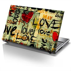 an open laptop computer covered in graffiti on a white background with the word love written all over it