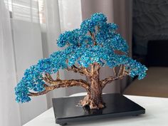 Blue bonsai on table Bonzi Trees, Beaded Plants, Bead Tree, Beaded Tree, Elegant Nursery, Handmade Aesthetic, Handmade Tree, Japanese Bonsai, Tree Handmade