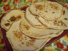 there are some tortillas that are on the red plate and one is yellow