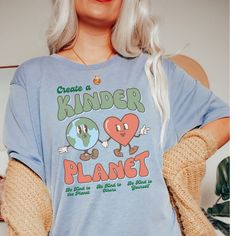 CREATE A KINDER PLANET. There is no Planet B! We love Bella + Canvas tees! A Unisex tee that's a perfect fit for every body. Soft and lightweight crewneck that fits like a well-loved favorite. ❤ If you would like the oversized fit look, please purchase a size 2 times larger than your regular size. ❤ ✦ PRODUCT INFO ✦ ▸ All items are printed just for you using water based eco-friendly & biodegradable inks.  ▸ 100% ring-spun cotton.  ▸ Sewn-in label. ▸ Please note: Colors may differ slightly in person than on a monitor or phone. ✦ CARE INSTRUCTIONS ✦ ▸ Machine wash cold, inside-out on a gentle cycle with a mild detergent and like colors. ▸ Tumble dry on low. ▸ Do not bleach and do not iron directly on design. ✦ SHIPPING TIMES ✦ Our products are processed & printed just for you when you order! Relaxed Fit Letter Print Tops For Earth Day, Casual Graphic Print Shirt For Earth Day, Casual Shirt With Graphic Print For Earth Day, Earth Day Graphic Print Crew Neck Shirt, Casual Screen Print Tops For Earth Day, Casual Tops With Earth Day Screen Print, Earth Day Letter Print Crew Neck Top, Earth Day Short Sleeve Top With Letter Print, Letter Print Crew Neck Top For Earth Day