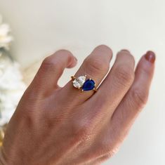 a woman's hand with a blue and white ring on it