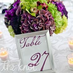 a table with candles and flowers on it is set up for a formal dinner or reception