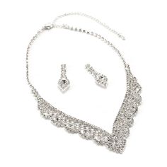 This bridal wedding jewelry set is simply stunning! This beautiful jewelry set is encrusted with clear, sparkling rhinestones in a sophisticated and elegant design. The necklace measures approximately 14" long with a 4" extender Chain for just the right fit. The matching Earrings measure approximately 1.5" long and 1.4g in weight. This set is perfect for brides, bridesmaids, pageants or any special event. This set coordinates with any color or style wedding dress or formal ensemble. Silver Bridal Sets With Diamond Accents, Silver Crystal Jewelry Sets With Diamond Accents, Silver Jewelry Sets With Diamond Accents And Crystal, Silver Jewelry Sets With Diamond Accents, Silver Bridal Set With Rhinestones And Cubic Zirconia, Silver Jewelry Sets With Rhinestones And Cubic Zirconia, Silver Cubic Zirconia Jewelry Sets With Rhinestones, Silver Rhinestone Bridal Necklace For Anniversary, Silver Bridal Necklace With Bling