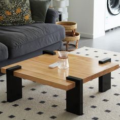 a coffee table sitting on top of a rug next to a couch