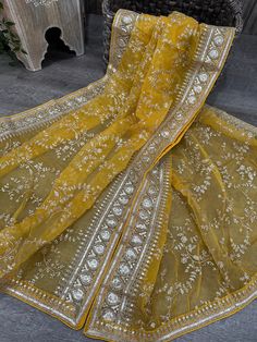 Yellow organza dupatta with gold embroidery jaal. Gold Tissue Silk Anarkali Set With Sheer Dupatta, Gold Anarkali Set With Sheer Dupatta In Tissue Silk, Gold Tissue Silk Dupatta For Designer Wear, Gold Dupatta For Festive Designer Wear, Festive Designer Gold Dupatta, Designer Gold Dupatta For Festive Occasions, Transitional Gold Tissue Silk Salwar Kameez, Transitional Season Gold Chanderi Anarkali Set, Gold Silk Anarkali Set With Sheer Dupatta