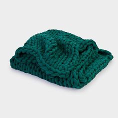 a green knitted dishcloth on a white background