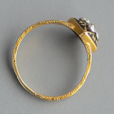 A beautiful antique Georgian (1714-1837) or Victorian (1837-1901) Era memorial or mourning ring with rose cut diamond & black enamel in 18k yellow gold. This wonderful ring features five glittering rose cut diamonds rub over set in sterling silver, as was typical of the period, in a quatrefoil or Tudor rose design atop a square of bezel gold turned on its axis and hand engraved with the void flooded with black enamel leading to equally beautifully hand engraved shoulders that are also enamel Tudor Rose, The Void, Three Stone Rings, Multi Stone Ring, Dream Jewelry, Rose Cut Diamond, Rose Design, Hand Engraving, Black Enamel