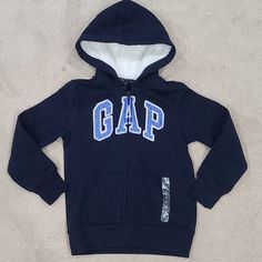 New With Tags Gap Kids Zipfront Hooded Logo Sweatshirt Size 6/7 (Small). Comes From A Smoke Free Home Gap Hooded Tops With Ribbed Cuffs, Gap Hooded Top With Drawstring, Gap Hooded Top With Drawstring Hood, Gap Cotton Hooded Top, Gap Long Sleeve Tops With Drawstring Hood, Gap Hooded Tops For Fall, Gap Hooded Sweatshirt For Winter, Winter Hooded Sweatshirt By Gap, Gap Hooded Winter Sweatshirt