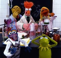 the muppets and beakers are sitting at a table