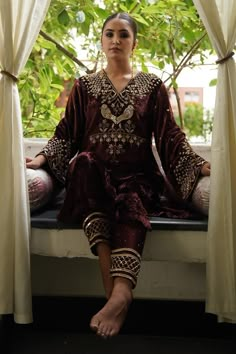 Dark brown straight kurta with zardosi, aari and kundan embroidery. Paired with a straight pant and dupatta.
Components: 3
Pattern: Embroidered
Type Of Work: Zardosi, Aari, Kundan
Neckline: Round V
Sleeve Type: Flared
Fabric: Kurta: Silk Velvet, Pant: Satin Silk, Dupatta: Silk Organza
Color: Brown
Other Details: 
Approx. product weight: 1.5 kg
Length:
Kurta: 45 inches
Pant: 38 inches
Note: Outfit worn by the model on the right is not for sale.
Occasion: Mehendi and Haldi - Aza Fashions Latest Suits 2023, Latest Velvet Suit Designs, Kundan Embroidery, Marriage Suit, Deepak Perwani, Mrunalini Rao, Velvet Suit Design, Red Anarkali, Velvet Kurta