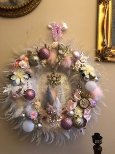 a wreath with ornaments hanging on the wall