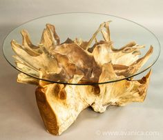 a glass coffee table with wood pieces on the top and bottom, in front of a white background