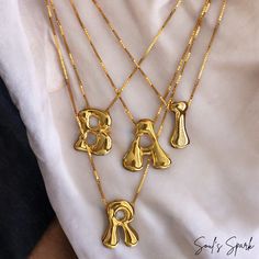 Elevate your summer style with our Bubble Letter Necklace, a stunning gold-plated monogram piece that combines fun and elegance. This balloon initial pendant is perfect for adding a personal touch to any outfit, whether you're hitting the beach or enjoying a night out. Crafted to be waterproof, this necklace is as durable as it is stylish, making it an ideal accessory for all your summer adventures. Unique Design: Features a charming bubble letter pendant that adds a playful yet sophisticated touch to your look. Gold Plated: Made with high-quality gold plating, ensuring durability and a brilliant shine that lasts. Waterproof: Designed to withstand summer activities, from beach days to pool parties, without losing its luster. Perfect Gift for Her: Whether it's for a birthday, anniversary, g Trendy Gold Necklaces For Personalized Gift, Customized Trendy Gold Necklaces, Trendy Customized Gold Necklaces, Gold Trendy Initial Necklace, Trendy Customizable Gold Necklaces, Trendy Gold Initial Necklace, Trendy Gold Pendant Initial Necklace, Trendy Gold Name Necklace, Gold Monogram Necklace In Trendy Style