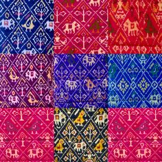 an assortment of different colors and patterns on fabric