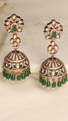 Discover the timeless elegance of these meticulously crafted jhumka earrings, designed to add a touch of regal charisma to your look. Festive Fusion Chandelier Earrings With Stone Work, Intricate Design Earrings For Festive Reception, Intricate Design Jhumkas For Diwali Reception, Kundan Fusion Jhumkas, Fusion Style Kundan Jhumkas, Fusion Kundan Jhumkas Drop Earrings, Diwali Reception Jhumkas With Intricate Design, Hand Set Jhumkas For Diwali Celebration, Elegant Green Jhumkas For Reception