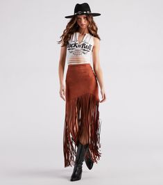 Channel your western side with this trendy-chic skirt that will level up your festival look! It features a high-rise waist, an asymmetric mini-length hem with a form-hugging fit, and long fringe detailing that cascades to your ankles. The stylish fringe design will dance with you to your favorite band! Complete your 'fit with a cropped graphic tee and cowboy boots.Fit & FeaturesHigh-rise waistBack zipper, hook and eye closureAsymmetric mini-length hemForm-hugging fitLong fringe design, ankle Fringe Outfits Western, Long Fringe Skirt Outfit, Fringe Skirt Concert Outfit, Western Fringe Skirt Outfit, Long Skirt With Tshirt, Western Skirt Outfits, Long Fringe Skirt, Fringe Skirt Outfit, Hippy Skirt