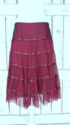 "Vintage sheer silk dark red ruffle midi skirt/mid length tiered festival skirt/90s burgundy/maroon silk skirt/large Features... -sheer 100% overlay -accented with metallic gold threading -stretch poly lining -midi length -zipper side -90's vintage Measurements...taken flat -marked size: large -across waist: 18\" -length: 29\" Condition... -excellent vintage condition -minimal wear UJ2065" Festive Ruffled Tiered Skirt Dresses, Festive Tiered Ruffled Skirt Dresses, Elegant Festive Ruffle Skirt, Festive Elegant Ruffled Skirt, Fall Tiered Ruffled Skirt, Festival Tiered Skirt Dress With Lined Skirt, Festival Dresses With Lined Tiered Skirt, Tiered Skirt Dress With Lined Skirt For Festivals, Fitted Tiered Maxi Skirt For Festival