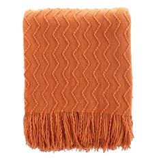 an orange blanket with fringes on it