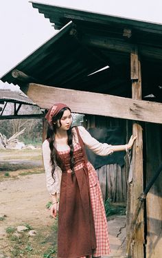 Early 19th century inspired village dress for everyday chores. This faux multi-layered dress features a white blouse part with a scoop neckline and three-quarter blouson sleeves, and a pinafore dress with plaid and ditsy floral patchwork layers. We've deliberately designed the floral patchwork to slant towards one side and attached it with an adjustable lace-up. There's a little pocket dangling at the waist to keep your phone or other knick-knacks. Full knit plaid skirt and partial linen brown s Casual Brown Patchwork Dress, Knee-length Brown Patchwork Dress, Brown Plaid Pinafore Dress, Cotton Cottagecore Pinafore Dress, Brown V-neck Patchwork Dresses, Brown Skirts, Pinafore Dress, White Blouse, Plaid Skirts