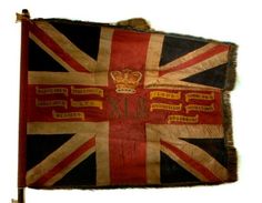 an old british flag hanging on the wall