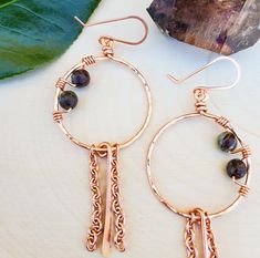 Handmade and hand hammered/textured copper hoop earrings with wire wrapped Jasper **Details** Earrings are approximately 3 inches 16g Copper wire handmade hoops 20g Copper handmade ear wires 6mm Faceted Dragons Blood Jasper gemstones **Important Info** *The colors may appear to be slightly different than the picture due to the natural variations in gemstones, as well as screen quality or settings. *Please handle with care as handmade items may be more fragile than factory made products. Artisan Copper Dangle Hoop Earrings, Hand Forged Copper Dangle Hoop Earrings, Hand Forged Copper Hoop Earrings With Dangle, Small Copper Wire Wrapped Hoop Earrings, Bohemian Dangle Hoop Earrings With Copper Wire, Bohemian Hoop Earrings With Copper Wire, Dragons Blood Jasper, Dragons Blood, Wire Work