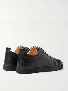 The 'Louis Junior' low-tops are a core design in Christian Louboutin's sneaker collection, and this 'Spikes' version perfectly melds the label's classic appeal and rock 'n' roll flare. They're made from smooth black leather, fitted with sleek tonal eyelets and laces, and finished with conical hardware on the toecaps. Wear them with slim, dark jeans. Designer Calf Leather Sneakers For Streetwear, Black Sneakers With Vulcanized Sole In Calf Leather, Black Calf Leather Sneakers With Vulcanized Sole, Red Sole Low-top Calf Leather Sneakers, Low-top Calf Leather Sneakers With Red Sole, Streetwear Low-top Sneakers With Leather Sole, Designer Low-top Custom Sneakers With Vulcanized Sole, Low-top Calf Leather Sneakers With Studded Outsoles, Designer Leather Sneakers For Streetwear