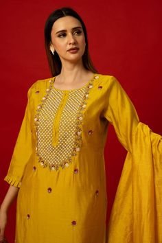 Elevate your wardrobe with the Yellow Silk Kurti Set. This set stands out with its intricate embroidery work. It transcends seasonal trends, offering versatility for various occasions. Whether it's a family gathering, festive celebration, or formal event, the Yellow Silk Kurti Set ensures you stand out with elegance. Its timeless appeal guarantees it as a cherished piece in your collection for years to come. Embroidered Slub Silk Palazzo Set For Navratri, Embroidered Silk Palazzo Set For Navratri, Art Silk Sharara With Floral Embroidery And Straight Kurta, Embroidered Slub Silk Palazzo Set, Embroidered Slub Silk Sharara For Navratri, Embroidered Slub Silk Palazzo Set With Traditional Drape, Festive Slub Silk Sharara With Dabka Work, Traditional Slub Silk Palazzo Set With Resham Embroidery, Embroidered Raw Silk Palazzo Set With Traditional Drape