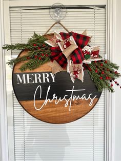 a merry christmas sign hanging on the front door