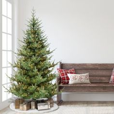 a small christmas tree next to a bench