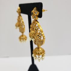 This beautiful earrings set has an excellent finish and gives out an exquisite sense of style. If you are looking for an amazing Fashion Jewelry set for special occasions such as Anniversary, Engagement, Party, Wedding, or for gifting, then your search ends here. Handmade Indian Temple Jewelry, best to wear it for traditional ceremonies or Indian wedding. This bridal jewelry has an ethnic finish. It has Cubic Zircon stones with semi-precious ruby and emeralds. It is a Bollywood style one gram je Elegant Gold Jewelry Sets With Drop Earrings, Elegant Latkans Earrings For Formal Occasions, Elegant Pearl Earrings With Latkans For Formal Events, Elegant Gold Plated Chandbali Jewelry Sets, Elegant Gold-plated Chandbali Jewelry Sets, Gold Drop Earrings Jewelry Sets For Wedding, Elegant Chandbalis With Latkans For Celebration, Gold Hand Set Bridal Earrings For Wedding, Gold Hand-set Bridal Earrings For Wedding