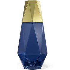 a blue and gold vase sitting on top of a white table