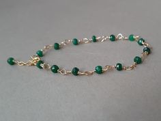 A beautiful, minimalist bracelet with deep green emerald rondelles Please measure tightly your wrist's circumference, using a ribbon or something similar, and then measuring the ribbon with a ruler. When ordering, please select the actual wrist size, not the size of the bracelet. I will make the bracelet fit your wrist, by adding approx 0.6 inch to the circumference. The bracelet was set up using gold filled wire and genuine emerald faceted rondelles. Available also with rose gold filled  or sterling silver findings. The bracelet is adjustable.  The listed gemstones can be replaced with others of your choice;  please convo me for custom orders.  Emerald is a stone of great harmony, wisdom and love, domestic bliss, sensitivity, loyalty, memory, mental capacity, harmony, focus, eliminating n Green Onyx Bracelets - Gift, Elegant May Birthstone Beaded Bracelets With Faceted Beads, Emerald Bracelets For May Birthstone, Green Onyx Beaded Bracelets As Gift, Elegant May Birthstone Faceted Beaded Bracelets, Green Emerald Bracelet For May Birthstone, Faceted Beads Bracelets As May Birthstone Gift, May Birthstone Spacer Beads Jewelry Gift, Faceted Beads Bracelet For May Birthstone Gift