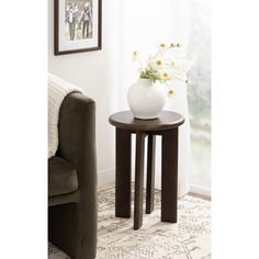 a small table with a vase on top of it